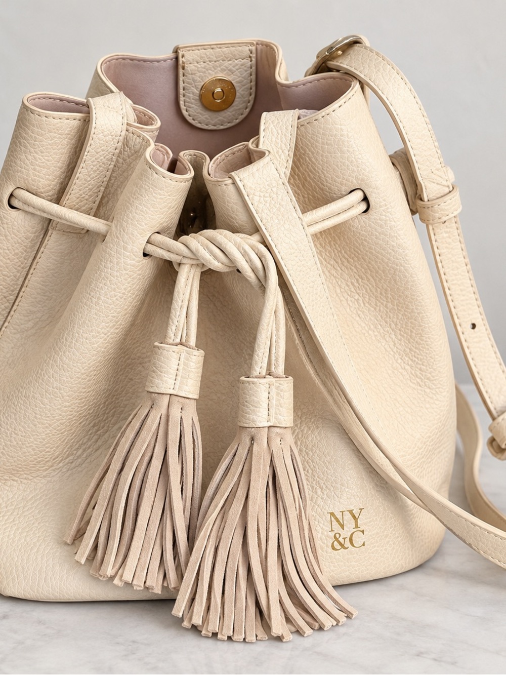 New York & Company Cream Tassel Drawstring Bucket Crossbody Bag